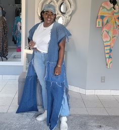 a woman standing in front of a mirror wearing jeans and a white t - shirt