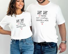 a man and woman standing next to each other wearing t - shirts that say 10 years and celebrating