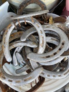 a bucket filled with lots of rusty metal rings on top of a white tablecloth