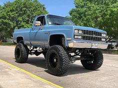 a blue truck is parked on the street