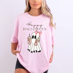 Check out more of what we offer!! Find our Etsy shops at: https://amoremiodesignllc.etsy.com https://chicsipsboutique.etsy.com THANK YOU FOR SHOPPING WITH US Introducing our adorable and festive Pink Bow Happy Halloween Ghost t shirt - perfect for all the pumpkin spice lovers out there! This Halloween graphic tee features a friendly ghost holding not one, but TWO pumpkin spice lattes, because let's face it, one just isn't enough. And to top it off, she's rocking a gorgeous pink bow on her head, Fun Halloween Short Sleeve Shirt, Halloween Character Print Pink Top, Pink Halloween Graphic Tee, Spooky Pink T-shirt For Halloween, Pink Halloween T-shirt With Character Print, Cute Orange Halloween T-shirt, Cute Halloween Short Sleeve Tops, Cute Short Sleeve Halloween Tops, Cute Orange Top For Halloween