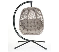 a swing chair with an iron frame and grey cushions on it's legs, in front of a white background