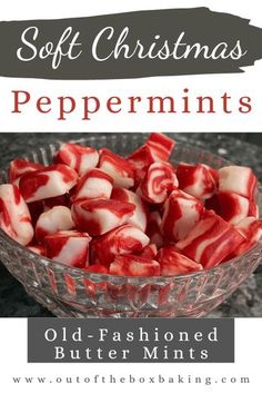 a glass bowl filled with red and white peppermints on top of a table