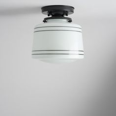 a white light hanging from the ceiling in a room