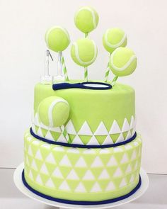 a green cake with tennis balls on top