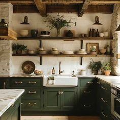 a kitchen filled with lots of green cabinets and counter top space next to an oven