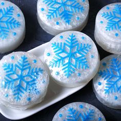 snowflake cookies on a white plate with blue icing