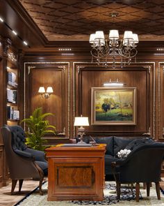 an elegant living room with wood paneling and chandelier hanging from the ceiling