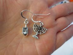 Hanukkah or Chanukah simple silver earrings Menorahs and Dreidels The 3 dimensional charms are sterling silver plated (nonlead) and made in USA. The ear wires are sterling silver --- choose between regular ear wires (soft ear nuts included) , posts (will have soft ear nuts and are 1/2" long, may be a flower or a ball) or sterling silver lever backs. Hypoallergic wires are available as well. Now we are offering hypoallergic leverbacks.All my earrings come with ear nuts. You will receive a brand n Sterling Silver Star Of David Charms Jewelry, Minimalist Star Of David Sterling Silver Jewelry, Minimalist Sterling Silver Star Of David Jewelry, Sterling Silver Charm Earrings As Gift, Sterling Silver Earrings With Charms For Gifts, Sterling Silver Drop Earrings With Charms, Sterling Silver Dangle Earrings With Charms, Dainty Sterling Silver Charm Earrings, Sterling Silver Jewelry For Hanukkah Gifts