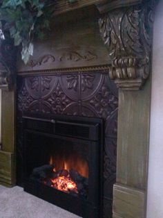 a fire place in the middle of a living room with an ornate fireplace and wood paneling