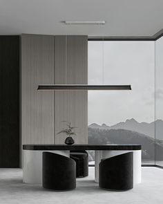 a modern dining table with black and white chairs in front of a large window that overlooks the mountains