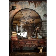 an old table with a mirror and books on it