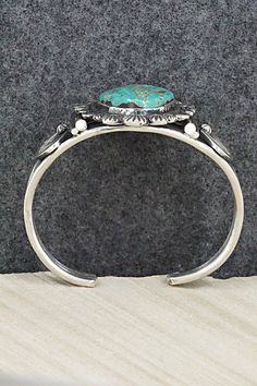 This beautiful turquoise and sterling silver bracelet was made by Navajo silversmith Jess Martinez. The inside is signed and stamped sterling.Size: 5 1/2" (will fit up to a 6 1/2" wrist)Gap: 1"Width: 1 5/8"Free shipping on all orders! We ship with USPS and always include tracking. All orders ship within a day of payment.Returns are accepted up to 30 days after you receive your order. Just send us a message. Our shop offers cash back or store credit. The item must be returned in new condition. Stamped Turquoise Sterling Silver Bracelet, Sterling Silver Turquoise Stamped Bracelet, Stamped Sterling Silver Bracelet In Turquoise, Bohemian Oval Sterling Silver Bracelet, Sterling Silver Bracelet, Turquoise Sterling Silver, Sterling Silver Bracelets, Silver Bracelet, Gap