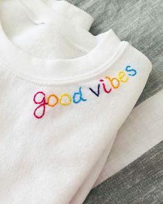 a white shirt with the word good vibes embroidered on it