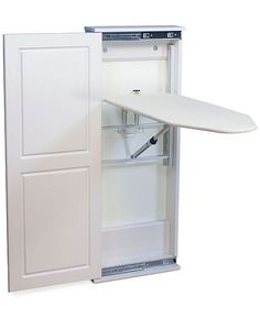 an ironing board is attached to the back of a white cabinet with its door open