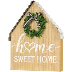 a wooden sign that says home sweet home with a wreath on the front and side