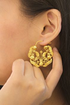 Elevate your wedding look with our statement Oversized Felicia Creolla Earrings, handcrafted by Filipino goldsmiths from Ilocos using the art of gold filigree. Each gold thread is carefully shaped by hand into "kalado" or lace-like patterns inspired by nature. Wear a piece of home on your special day. Click to shop bridal jewelry. Filipiniana weddings | Dream Filipino wedding | FilAm weddings| Filipino American weddings | AAPI weddings | Beach weddings | Wedding fashion inspo | Heirloom jewelry Ilocos Sur, Filipiniana Wedding, Filipino Wedding, Weddings Beach, Heirloom Jewelry, Heirlooms Jewelry, Wedding Look, American Wedding, Gold Thread