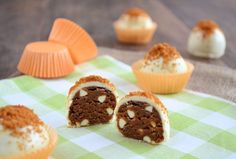 several cupcakes with frosting and toppings on a green checkered cloth