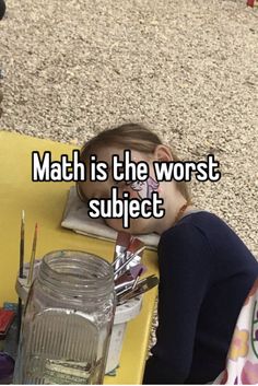 a child sitting at a table with the words math is the worst subject on it