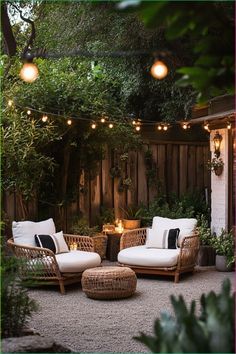 an outdoor seating area is lit up with string lights and wicker furniture, surrounded by greenery