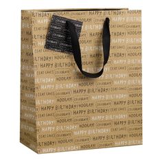 a brown paper bag with black handles and the words happy birthday printed all over it