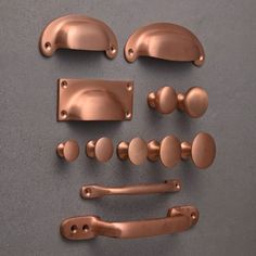 an assortment of handles and knobs on a gray surface