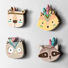 four wooden animal magnets with different designs on them