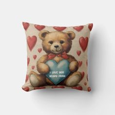 a pillow with a teddy bear holding a heart