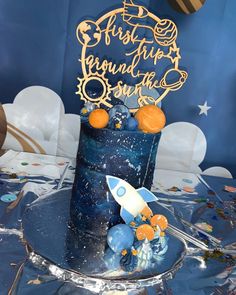 a space themed birthday cake with an astronaut theme on the top and stars in the background