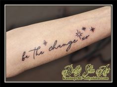 a person with a tattoo on their arm that says be the charge in black ink