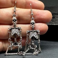 Get ready to dance the night away with these one-sided skeleton earrings in a vintage metallic silver finish! Perfect for any occasion - Halloween, Day of the Dead, a birthday party, or a night out with friends. Lightweight, articulated (all limbs are movable) and beautifully detailed, these earrings make a unique and original gift for yourself or someone special. Add some gothic, punk, and tattoo fashion to your look with these playful and quirky CALACAMANIA™ accessories Earrings details: Size: Gothic Skull Earrings For Halloween, Silver Grunge Jewelry For Party, Nickel-free Skull Jewelry For Party, Silver Metal Jewelry For Costume Party, Punk Skull Earrings For Party, Edgy Skull Earrings For Parties, Gothic Skull Earrings For Party, Edgy Silver Earrings For Halloween, Punk Halloween Party Earrings