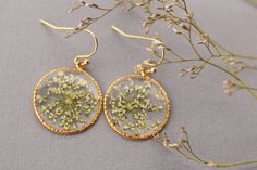 Botanical earrings made from real dried flowers and clear resin. A wonderful gift for nature lovers. Details: Size in diameter: 2 cm (Let me know if you want other size ) Material: Clear resin, real dried flowers Metal: Gold plated brass Ready to ship **Your new earrings will arrive safely packaged in beautiful bag with our logo, complete with a card. A wonderful gift for you and your loved ones. Usually delivery takes 20-40 days depends on country, but please be aware that it could sometimes ta Nature-inspired Teardrop Earrings With Pressed Flowers, Yellow Pressed Flower Earrings, Gold Flower-shaped Earrings With Pressed Flowers, Girlfriend Necklace Gift, Real Flower Earrings, Pressed Flower Earrings, Yellow Flower-shaped Earrings With Pressed Flowers, Flower-shaped Resin Earrings With Pressed Flowers, Flower Earrings Gold