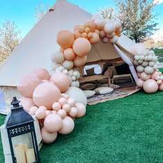 a tent decorated with balloons and candles