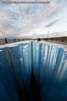 a man riding a skateboard on top of an ice covered ground