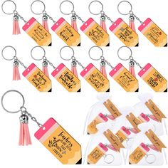 a bunch of tags with tassels attached to them and some keychains