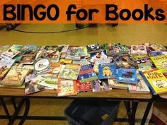 there is a table with many children's books on it and an orange sign that says, bingo for books