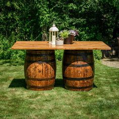 two wooden barrels sitting on top of grass