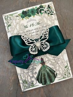 a card with a green bow and lace