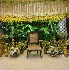 a chair sitting in front of a bunch of flowers