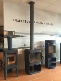 several wood burning stoves in front of a sign that says timeless norwegian craft