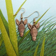 "These delightful bronze donkey earrings are beautifully detailed. As the artist, I happen to think they are real conversation starters as well! Handcrafted and designed in America (in my own studio each earring is 7/8\" tall and 5/8\" wide across the ears. Your bronze earrings will come on bronze ear wires. These ear wires are nonreactive for most people. The little donkeys will come in a sturdy, American-made gift box. The Magic Zoo's logo is on the lid, in beautiful apple green. Perfect for k Puppy Cut, Bronze Earrings, Bronze Jewelry, Donkeys, Silver Pieces, Conversation Starters, Matching Necklaces, Gold Design, Ear Wires