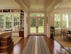 a living room filled with furniture and lots of windows