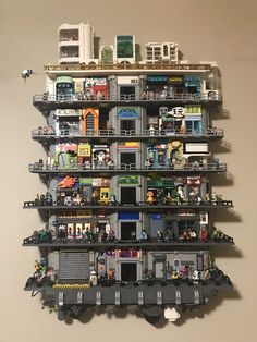 a tall building made out of legos and other toys on top of each other