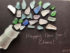 a card with sea glass on it that says happy new year