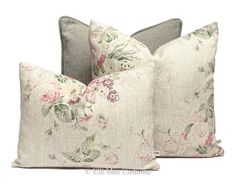 two pillows with floral print on them, one is grey and the other has pink flowers