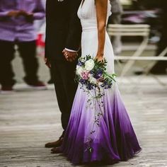 a man and woman standing next to each other in formal wear with flowers on their bouquets