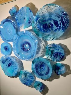 several blue glass bowls sitting on top of a table