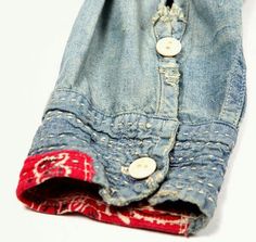 an old pair of jeans with buttons on the back and inside are folded up to show how much fabric has been used