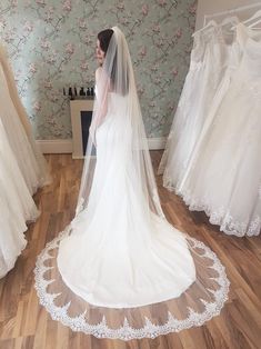 the bride is looking at her wedding dress