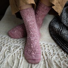 a person wearing pink socks and brown pants